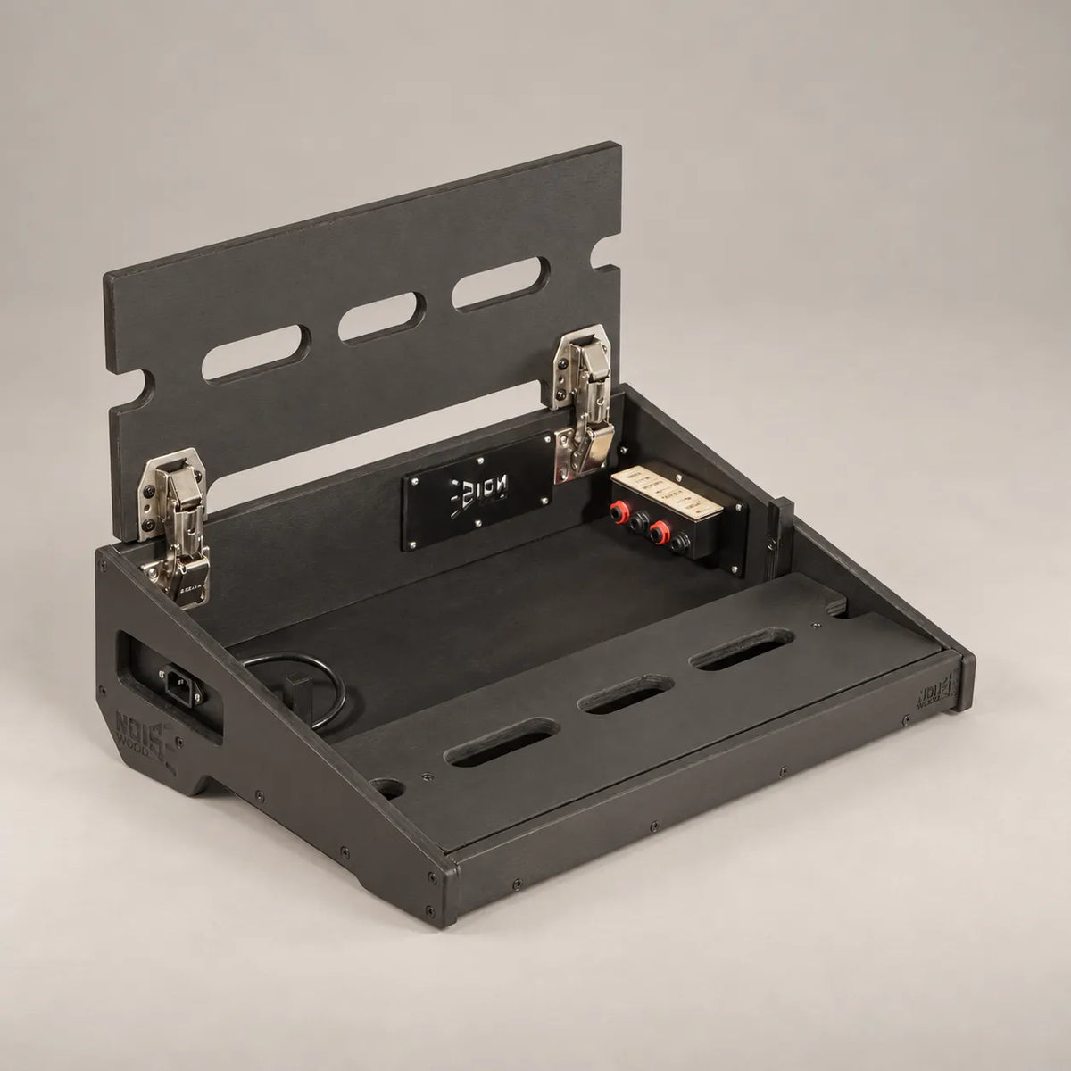 Core D340/450 Stealth Black pedalboard with the top deck lifted, showing the in/out connection panel inside