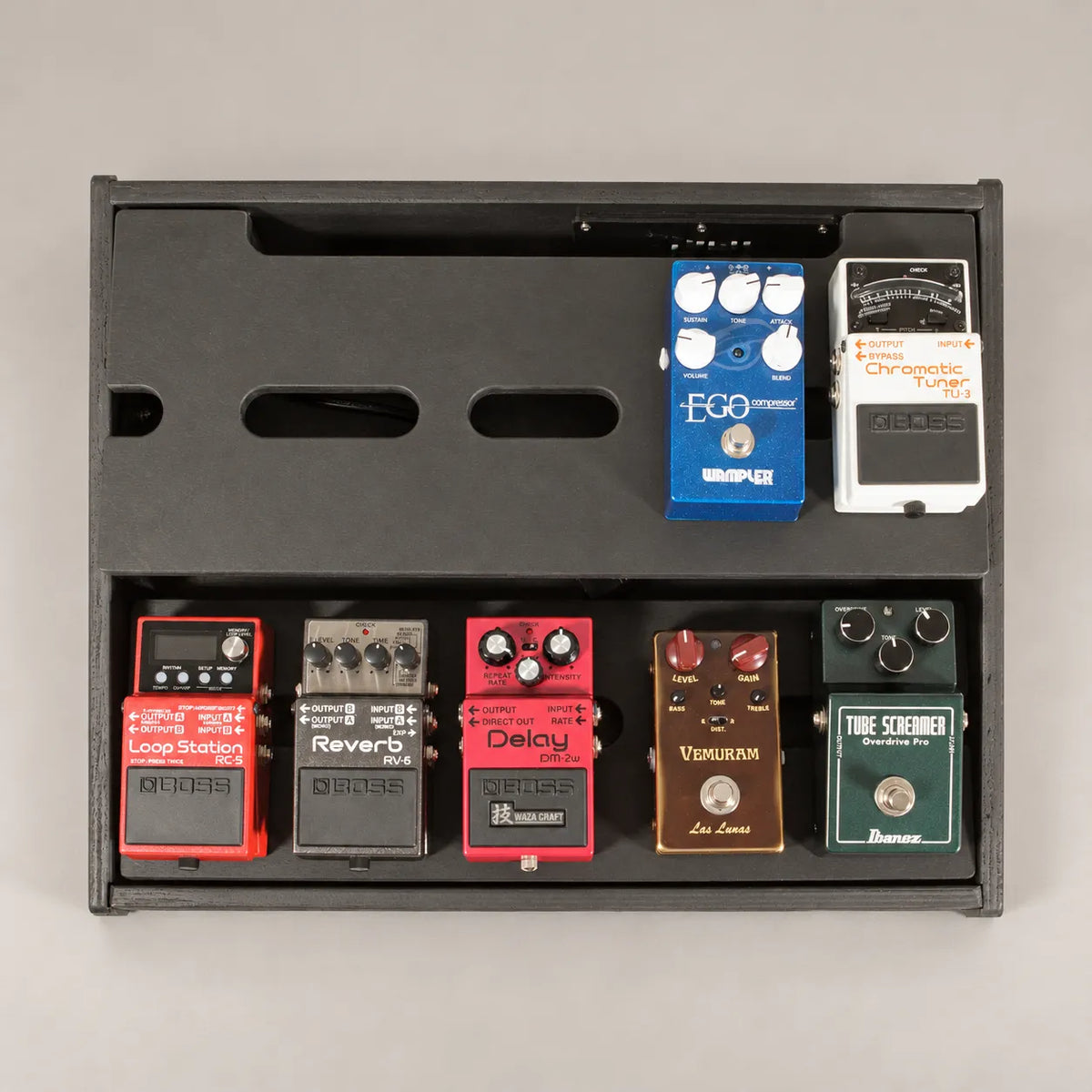 Core D340/450 Stealth Black pedalboard seen from above with seven guitar pedals across both decks