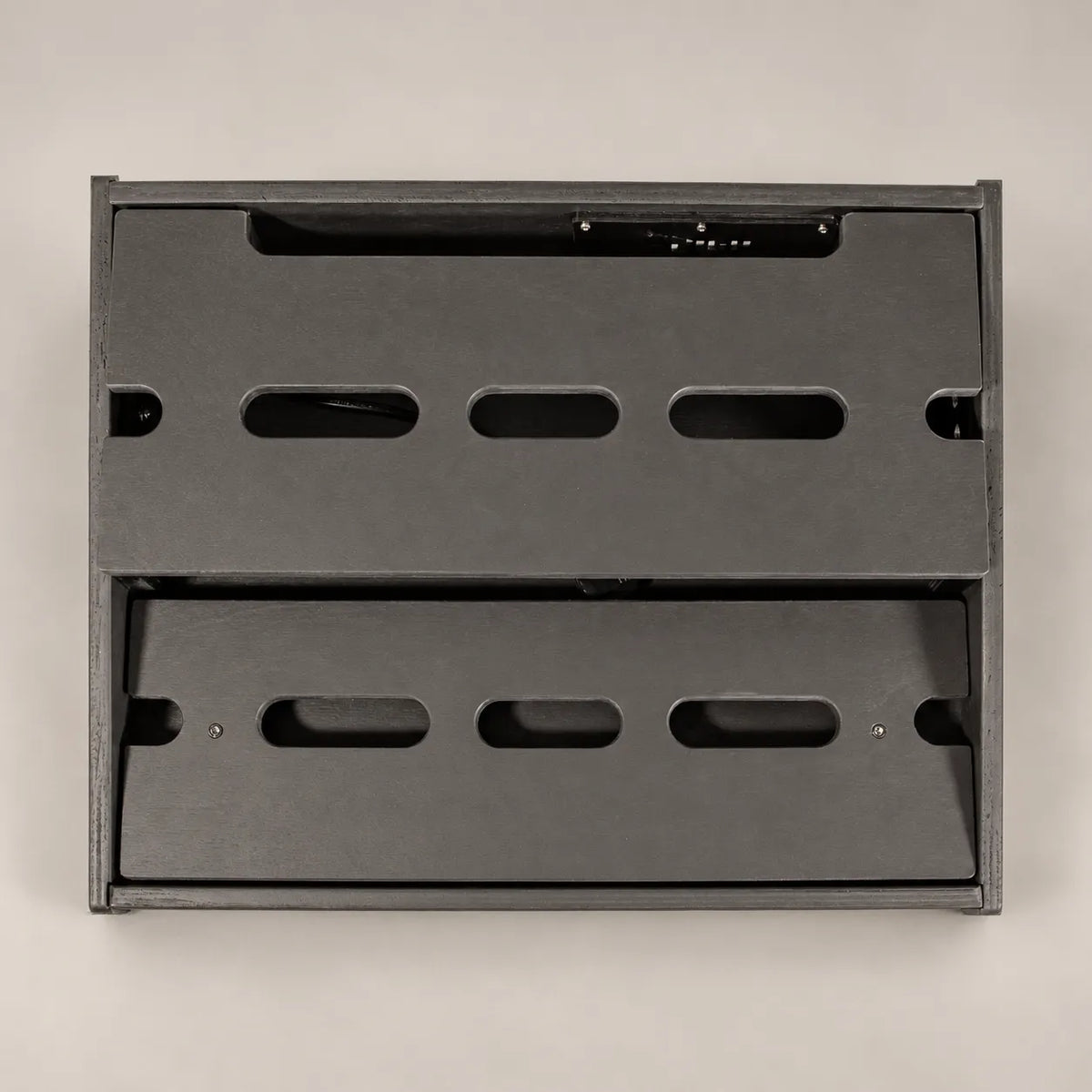 Empty Core D340/450 Stealth Black pedalboard seen from above, showing both decks and the cable slots
