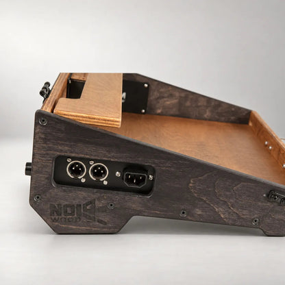 Left side panel of the Noisewood Noble D340/450-TM pedalboard with two XLR outputs and the integrated 230V power inlet