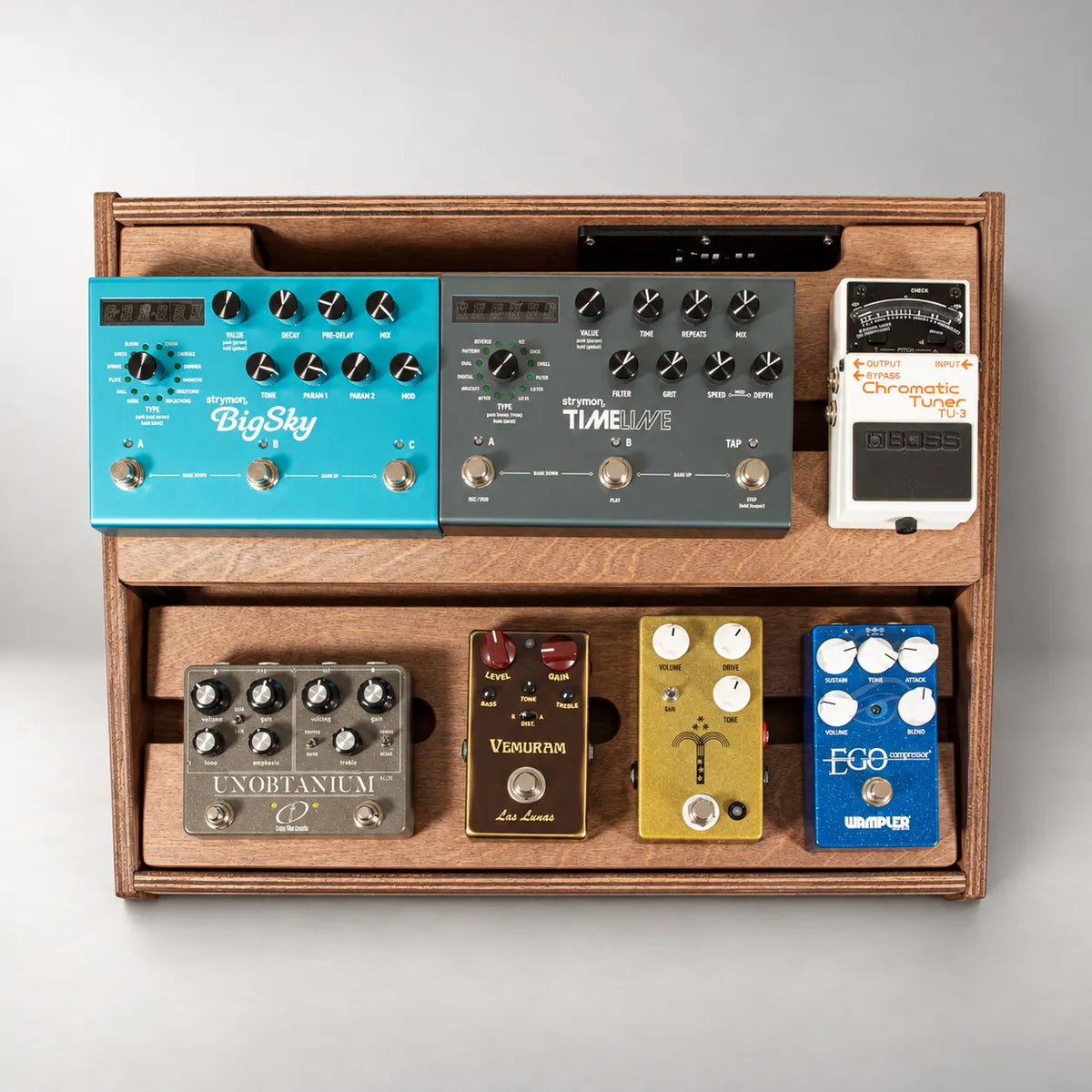 Studio D340/450 Walnut pedalboard seen from above, loaded with boutique guitar pedals across both decks