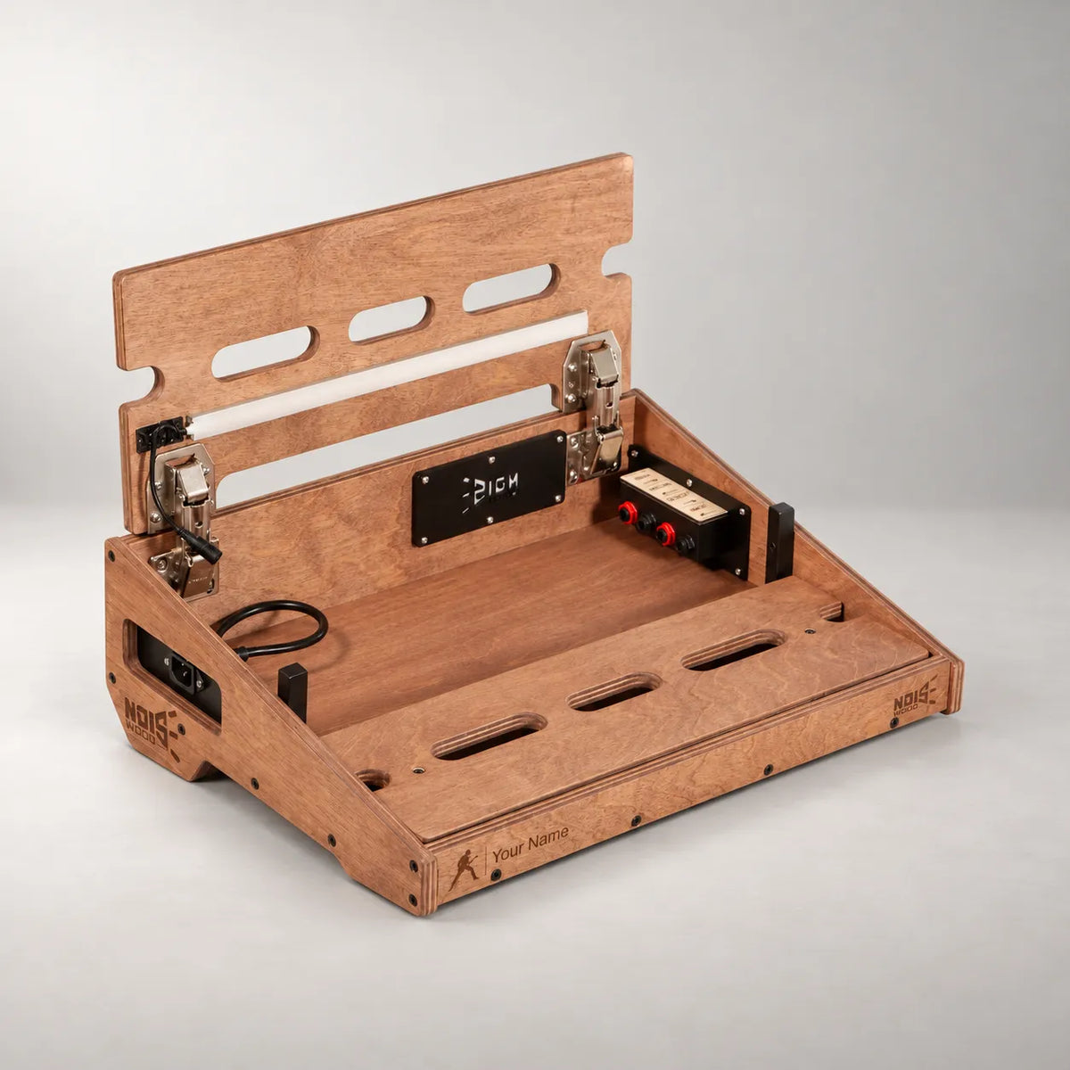 Studio D340/450 Walnut pedalboard with the top deck lifted, showing the internal connection panel and power