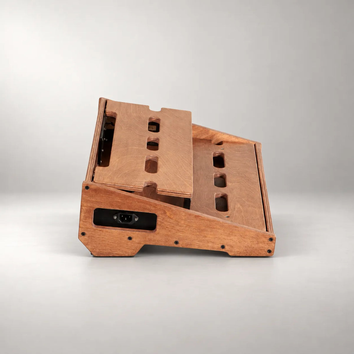Integrated 230V power inlet in the stained side panel of a Studio D340/450 Walnut pedalboard